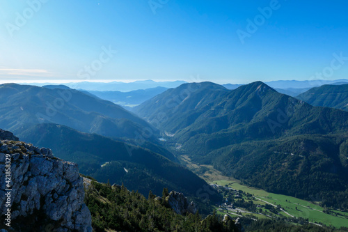 The view on the Alpine valley from the way to Hohe Weichsel in Austria. There is a dense forest on the steep slopes. View on Hochschwab. Clear and bright day. Calmness and peace.