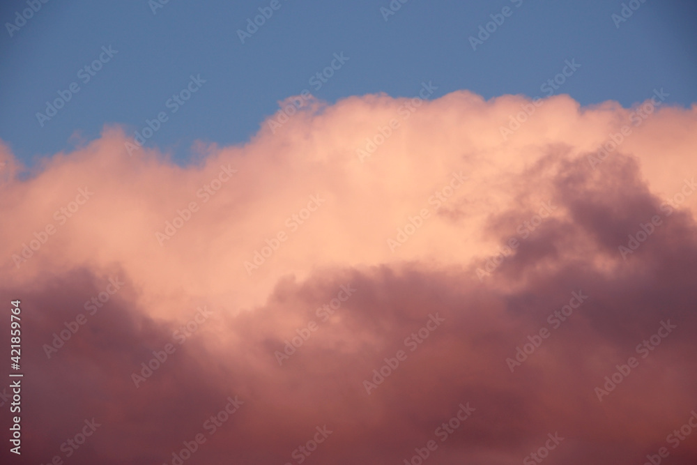 blue sunset sky with heavy fluffy cumulus clouds