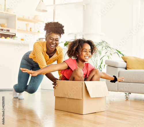 child family mother fun happy girl happiness daughter box together relocation moving cardboard box photo