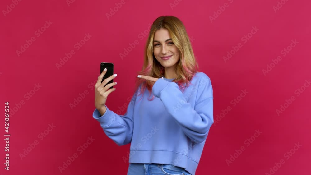 Young blonde woman using mobile phone over isolated background