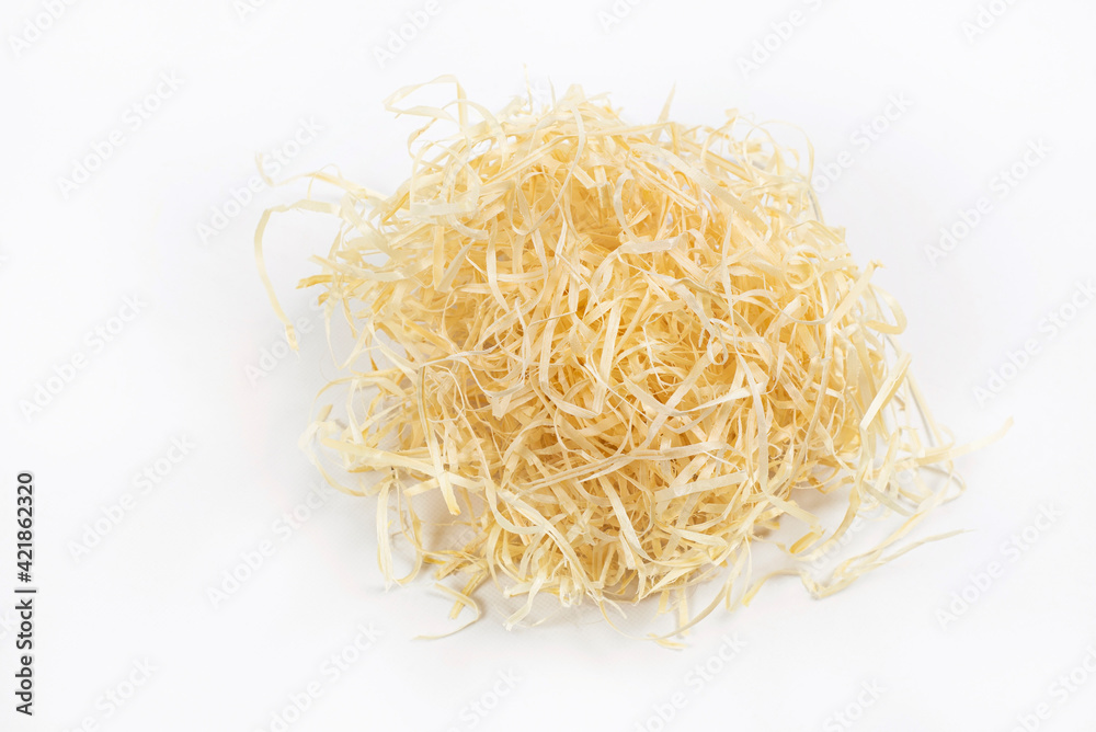 Light wood shavings on a white background for bedding in cages for pets, and for packing of the goods which are easily broken