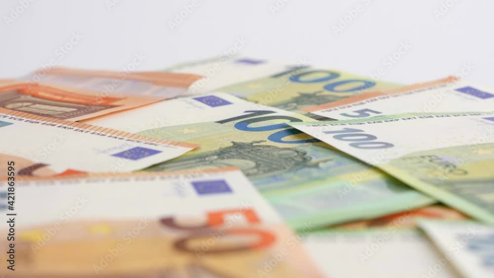 Banknotes background. Fifty and one hundred Euro notes in orange and green color covering the floor. Money currency of Europe. Banknotes background. Fifty and one hundred Euro notes in orange and green color covering the floor. Money currency of Europe.
