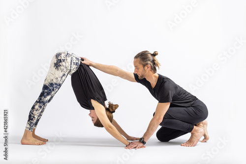 (4-4) Downward Facing Dog Pose (Adho Mukha Svanasana). Yoga teacher correcting a student's posture.