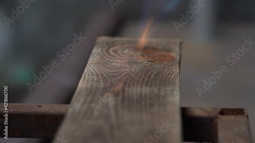 brushing wood with fire, burning wood with fire, burner