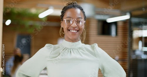 Smiling young businesswoman
standing in an office
