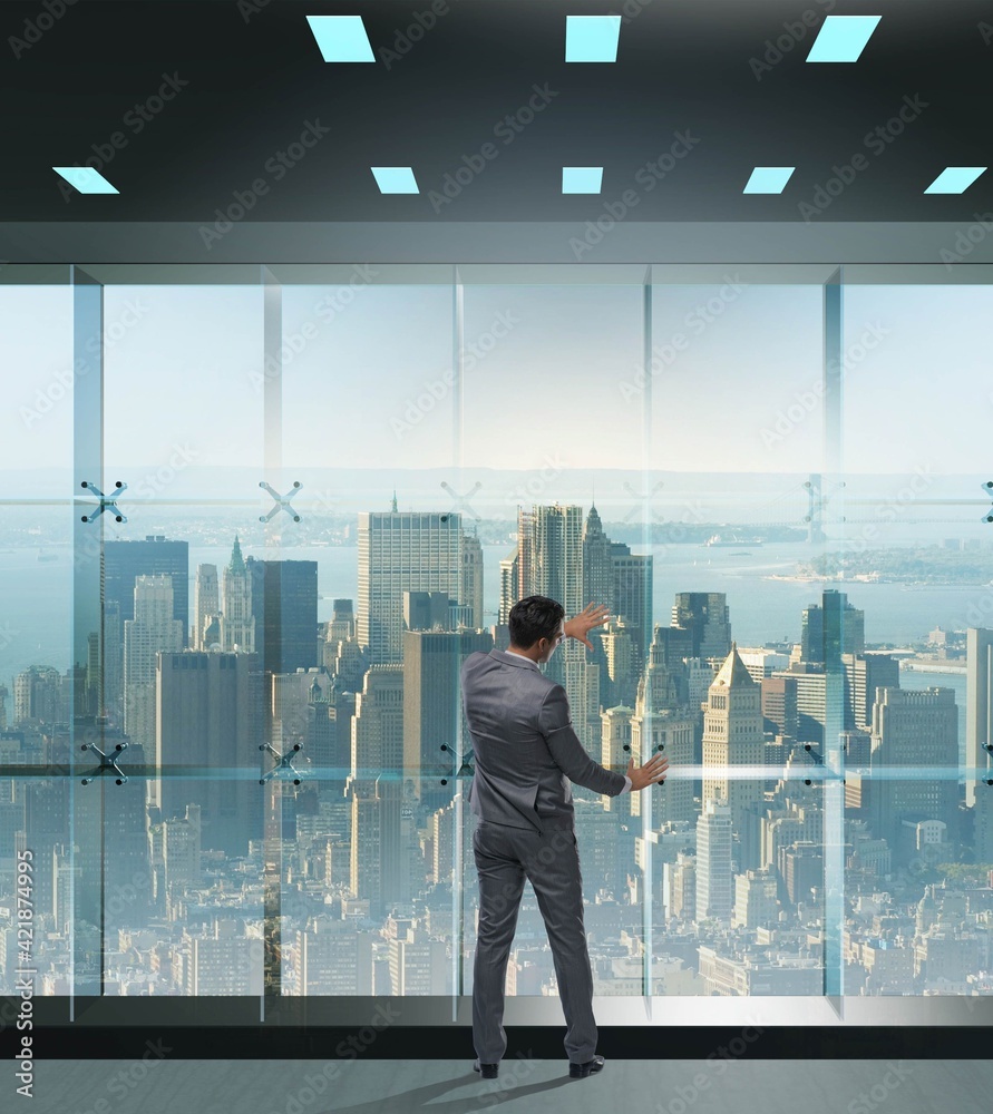 Fototapeta premium Businessman in front of office window thinking of new challenges