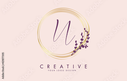 Handwritten N Letter logo design with golden circles and purple leaves on branches around. Vector Illustration with N letter.