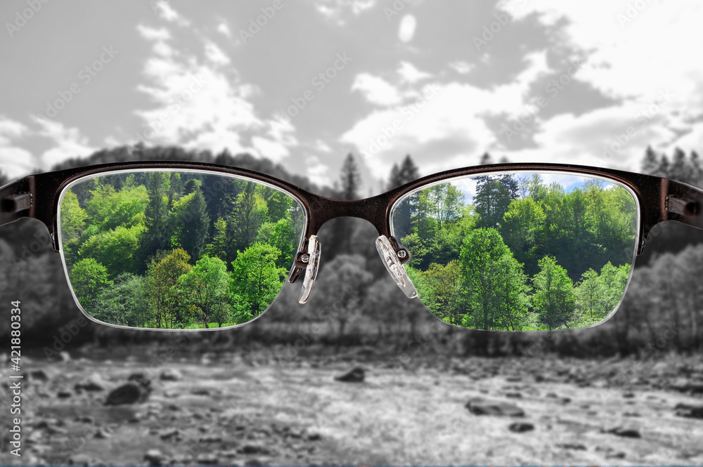 Colorful view of river and forest focused in women's glasses and monochrome background. View through eyeglasses. Better vision concept. Different world perception. - obrazy, fototapety, plakaty 