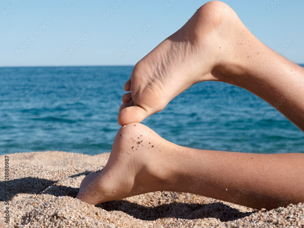 Woman feet closeup of girl relaxing on beach on sunbed enjoying sun on sunny summer day. Woman feet closeup of girl relaxing on beach on sunbed enjoying sun on sunny summer day.