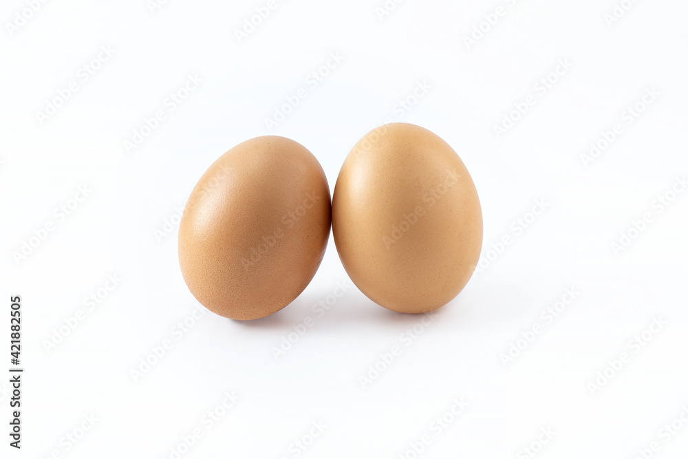 A pair of eggs on a white background. Isolated image of chicken eggs. Scrambled eggs, diet food preparation. Easter theme A pair of eggs on a white background. Isolated image of chicken eggs. Scrambled eggs, diet food preparation. Easter theme