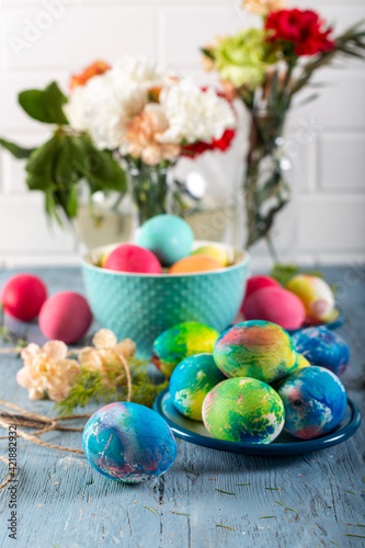Colorful easter eggs on a blue wooden table. 