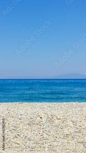 Pebble beach and blue sky. Life balance and harmony. Summer vacation concept. Minimalism