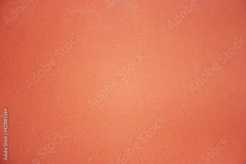 Close-up of painted surface. Bright color of a natural painted wall of the house. Fragment of a freshly painted wall. 