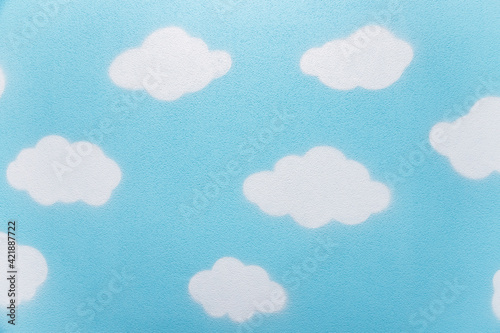 Children's wall painted with blue sky and clouds. Background