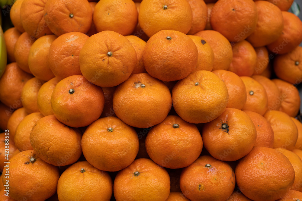 Group of colorful juicy tangerines in a food market Group of colorful juicy tangerines in a food market