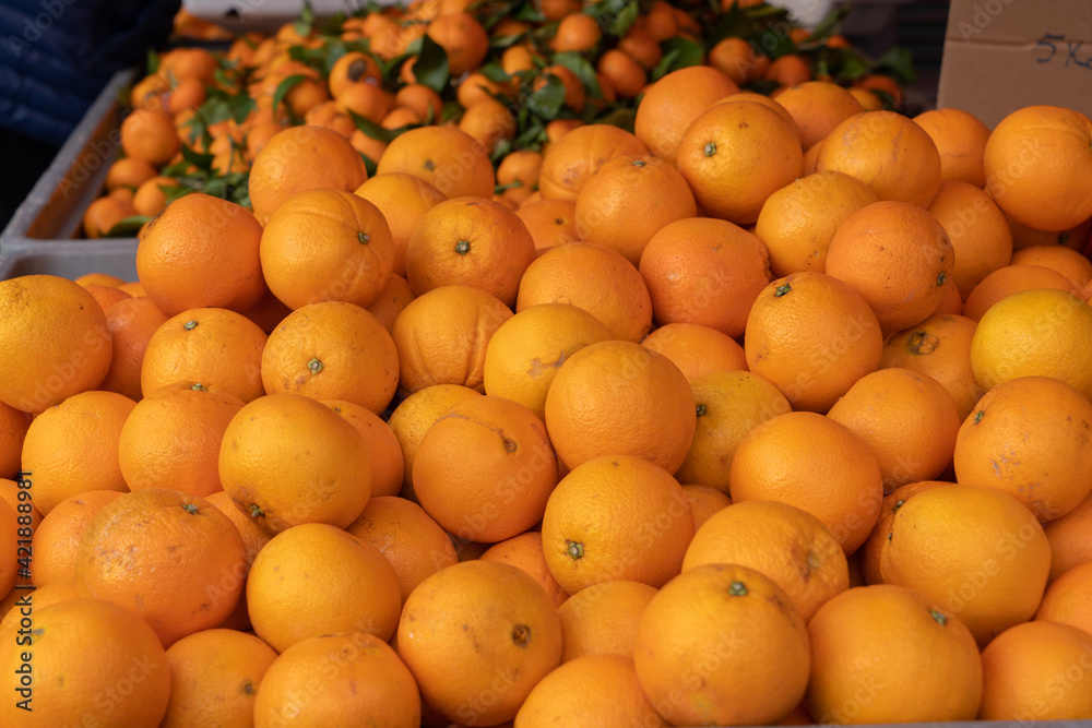 Group of colorful juicy tangerines in a food market