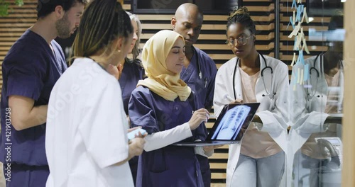 Diverse group of doctors looking
at an x-ray on a laptop
