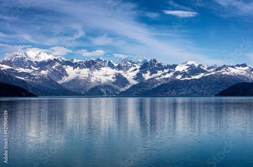 Wide view of Alaska Glacier bay landscape during late summer with ship going very close to the coastline