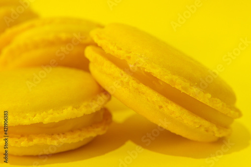 Yellow macaroons on yellow background