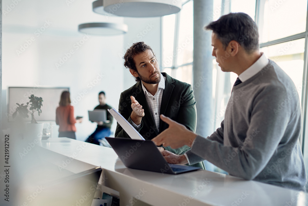Young businessman talks to his mentor while doing an internship at corporate company. Young businessman talks to his mentor while doing an internship at corporate company.