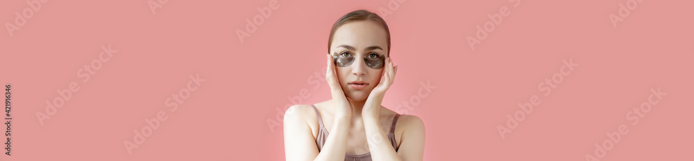 Head shot portrait close up smiling young woman with under eye moisturizing patches mask looking at camera enjoying skincare procedure Head shot portrait close up smiling young woman with under eye moisturizing patches mask looking at camera enjoying skincare procedure