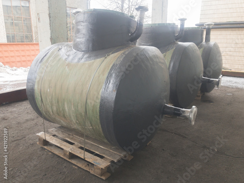 Green horizontal fiberglass container tanks of high strength and a wide range of uses: for sewerage, storage of drinking water and food supplies. ?hemical resistant tanks. photo