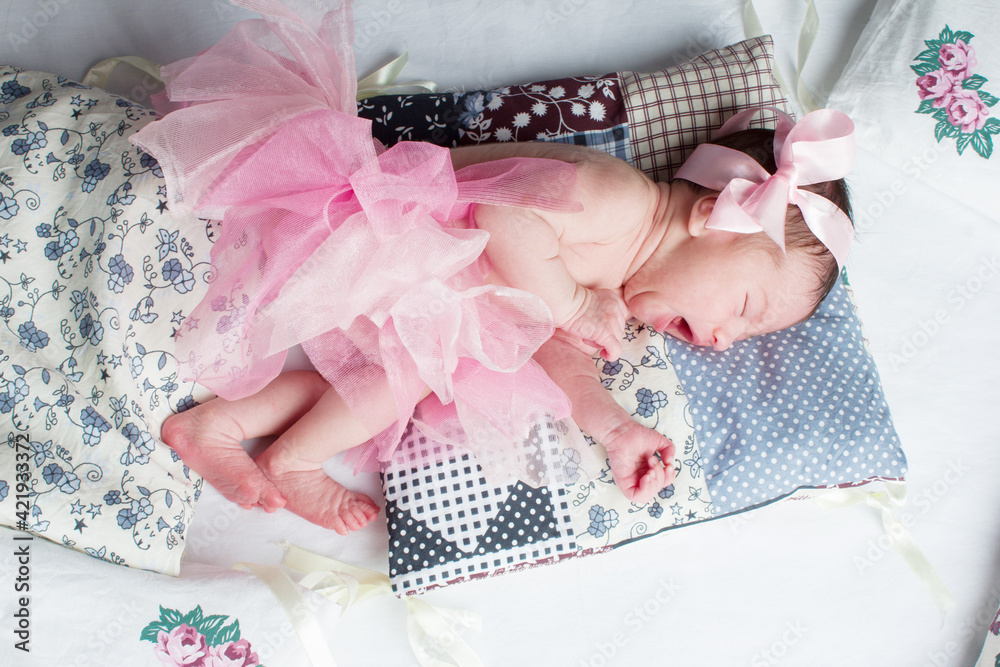 photo of a baby girl in a pink skirt and bow. photo of a baby girl in a pink skirt and bow.
