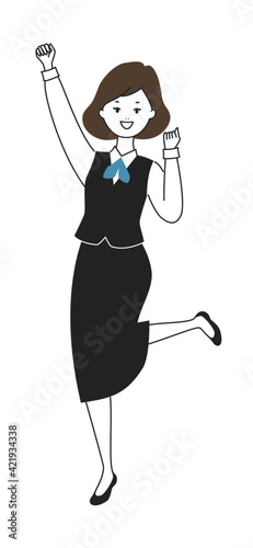 元気にガッツポーズをする制服姿の女性