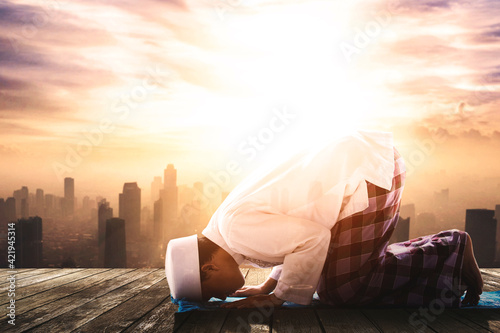 Muslim man is doing Salat with city background