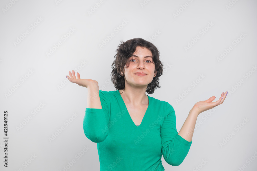 Portrait of happy attractive young girl spreading her arms on a white background