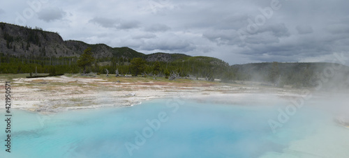 Late Spring in Yellowstone National Park: Sapphire Pool of the Sapphire Group in the Biscuit Basin Area of Upper Geyser Basin with the Madison Plateau in the Background