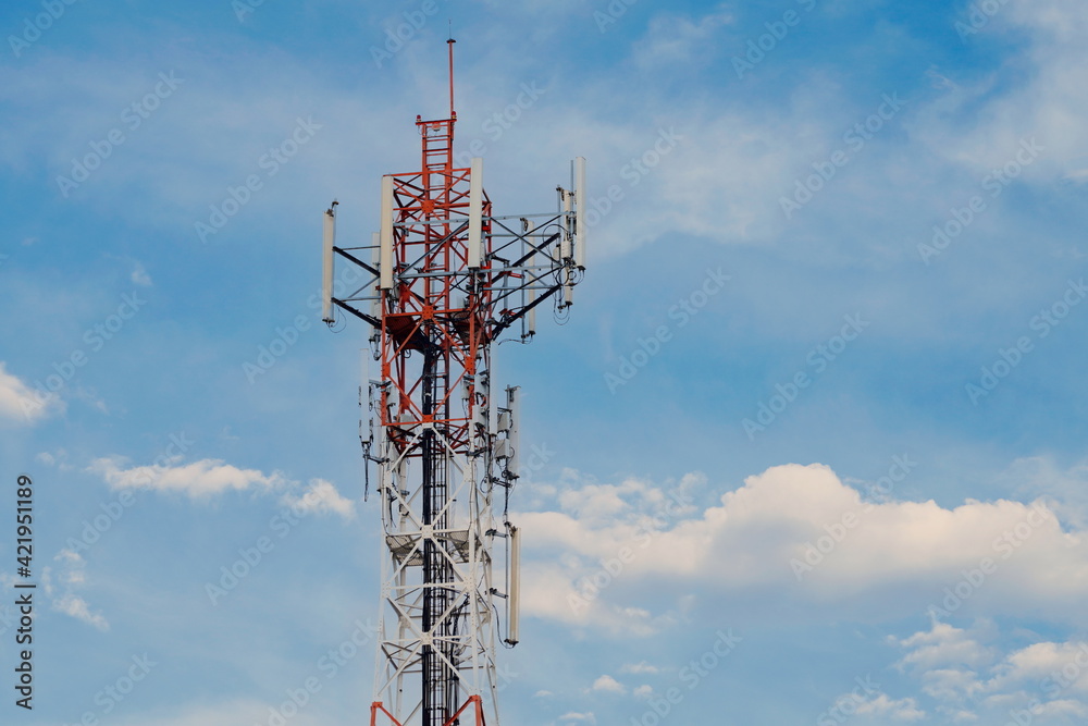 Telecommunication tower of 4G and 5G cellular. Macro Base Station. 5G radio network telecommunication equipment with radio modules and smart antennas mounted on a metal against cloulds sky background. Telecommunication tower of 4G and 5G cellular. Macro Base Station. 5G radio network telecommunication equipment with radio modules and smart antennas mounted on a metal against cloulds sky background.