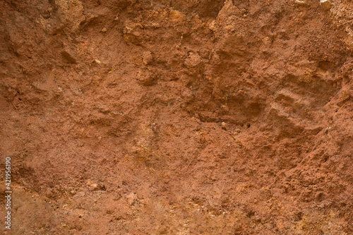 abstract side view of carving mountain earth soil  yellow or red color tone  oxidized and very fertile  soil red clay background  texture  full frame  flat surface backdrop for photography