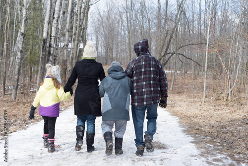Family of four out for a walk on a winter day