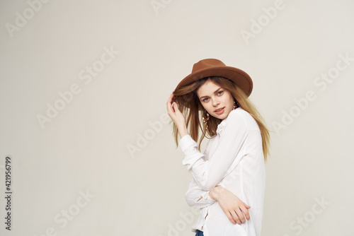 emotional woman wearing hat white shirt fashion studio cropped view