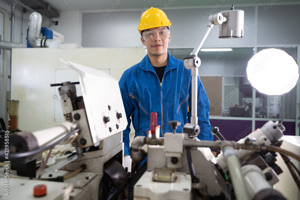 Portrait of Asian maintenance engineer workers working machines in the factory. Portrait of Asian maintenance engineer workers working machines in the factory.