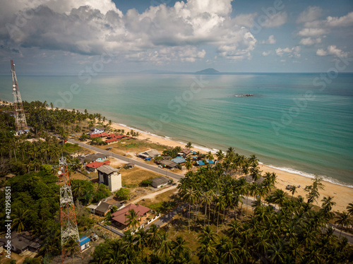 Aerial landscape photography of a fisherman village in the Terengganu coastal overlooking the mysterious depth of the South China Sea attracting nature lovers and tourists to seek the peace of mind. © nazkickass