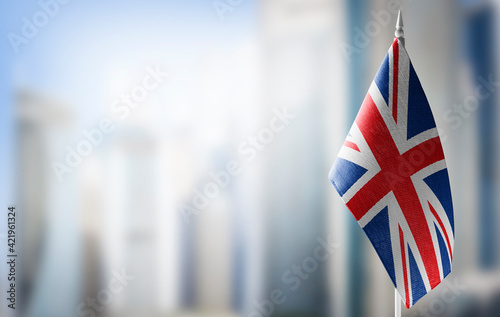 Fototapete A small flag of United Kingdom on the background of a blurred background