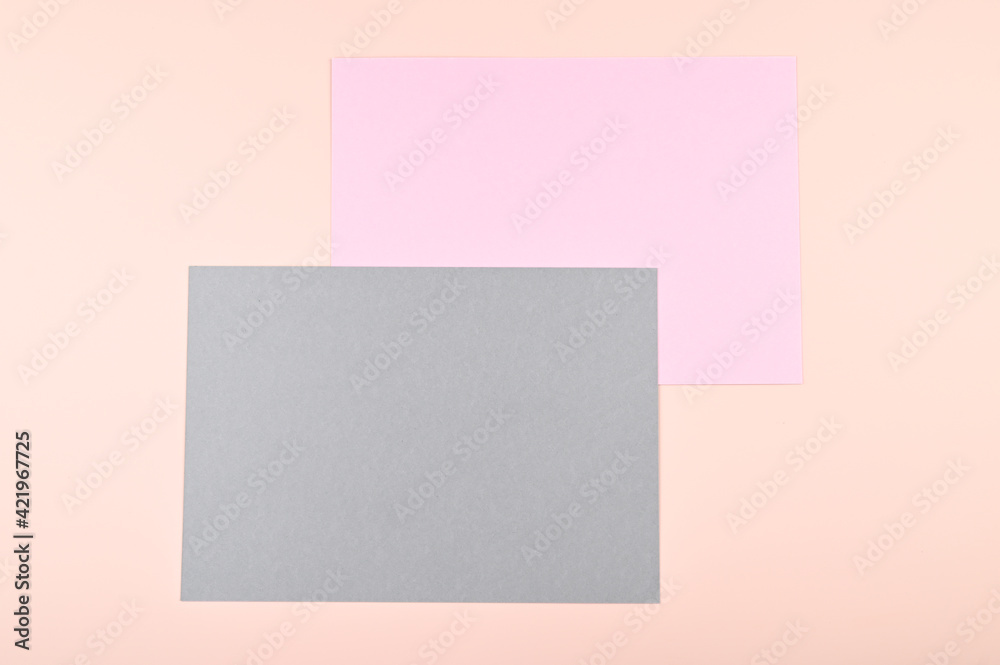 Empty sheets of pink and gray paper on pastel background. Creative design for pastel wallpaper.