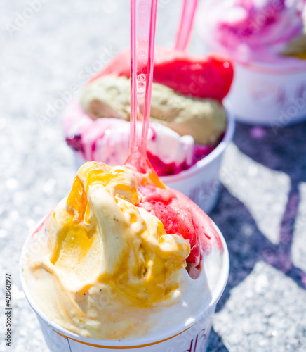 Photography gelato italian ice cream on the street in rome mango pistachio ice cream