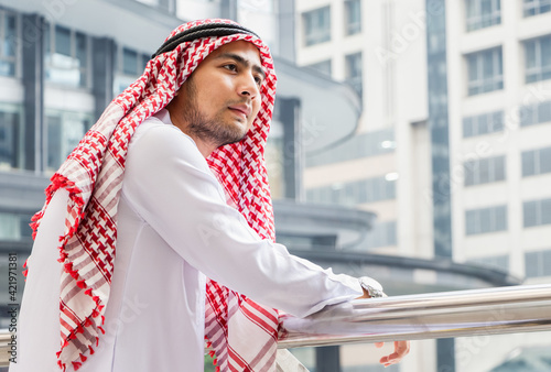 Portrait of Young Arab middle eastern man standing enjoy at outdoor city view background