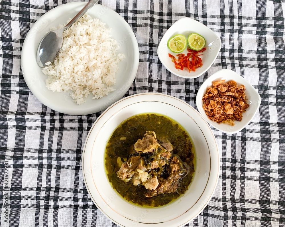 Nasu Cemba is a traditional food from Enrekang, South Sulawesi, Indonesia. Made from beef ribs and some condiments, served with rice, chilli, fried onion and kaffir lime. Nasu Cemba is a traditional food from Enrekang, South Sulawesi, Indonesia. Made from beef ribs and some condiments, served with rice, chilli, fried onion and kaffir lime.