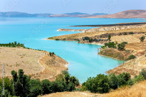 Ataturk Dam (GAP) near Samsat in the Adiyaman Province of eastern Turkey. On the right are paddocks of harvested grain crops