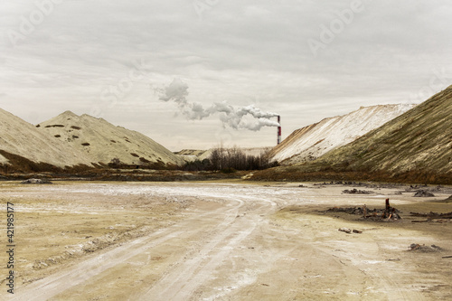 Dull landscape. Chemical mountains and industrial pipies.