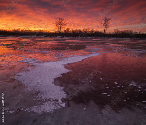 beautiful sunset reflected on the ice of the river
