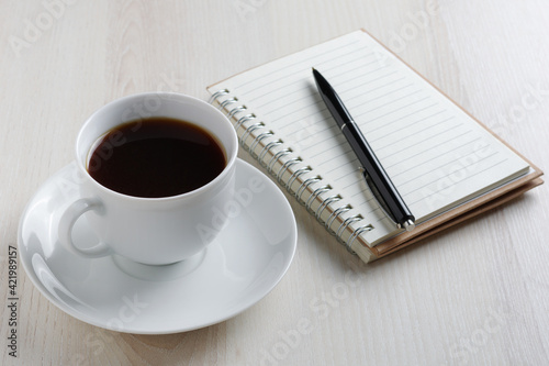 Coffee and notepad with pen