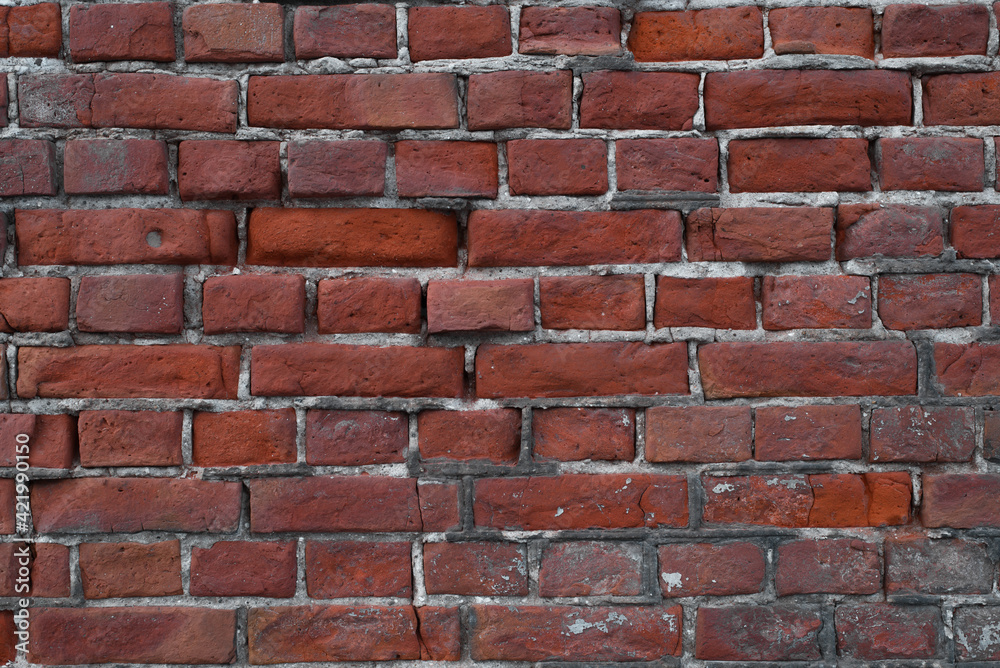 Obraz premium Old, broken wall of red bricks outside, close-up. Textured backdrop