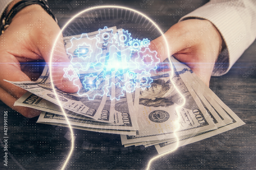 Multi exposure of brain drawing hologram and us dollars bills and man hands. Ai invest concept Multi exposure of brain drawing hologram and us dollars bills and man hands. Ai invest concept