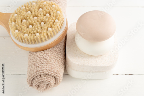 Spa, beauty cosmetics and body care treatment concept. Creative composition with bath accessories - massaging brush, soap bars and sponges on white background.