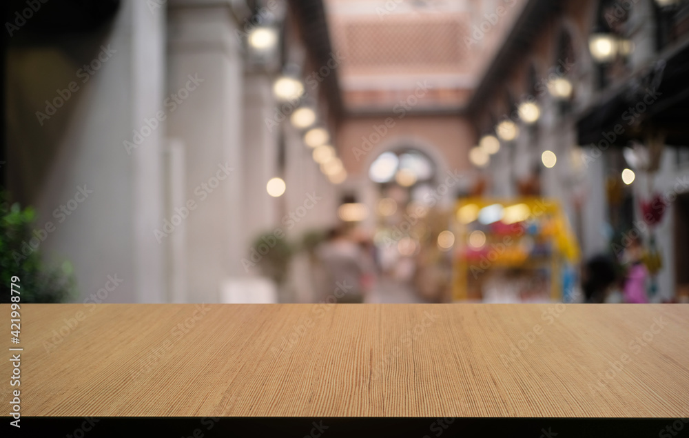 Empty dark wooden table in front of abstract blurred bokeh background of restaurant . can be used for display or montage your products.Mock up for space.